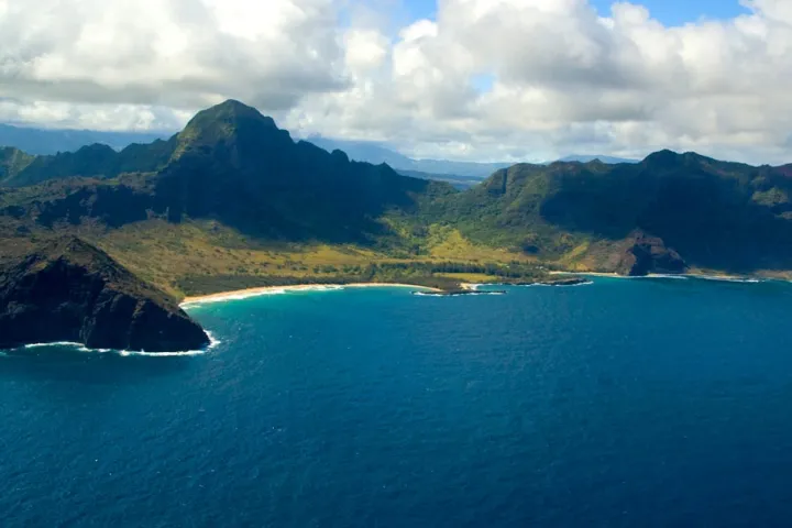 a body of water with a mountain in the background