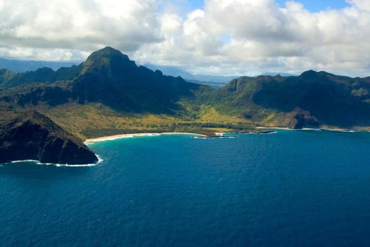 a body of water with a mountain in the background